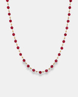 Collar en acero dorado  con piedras rojas.